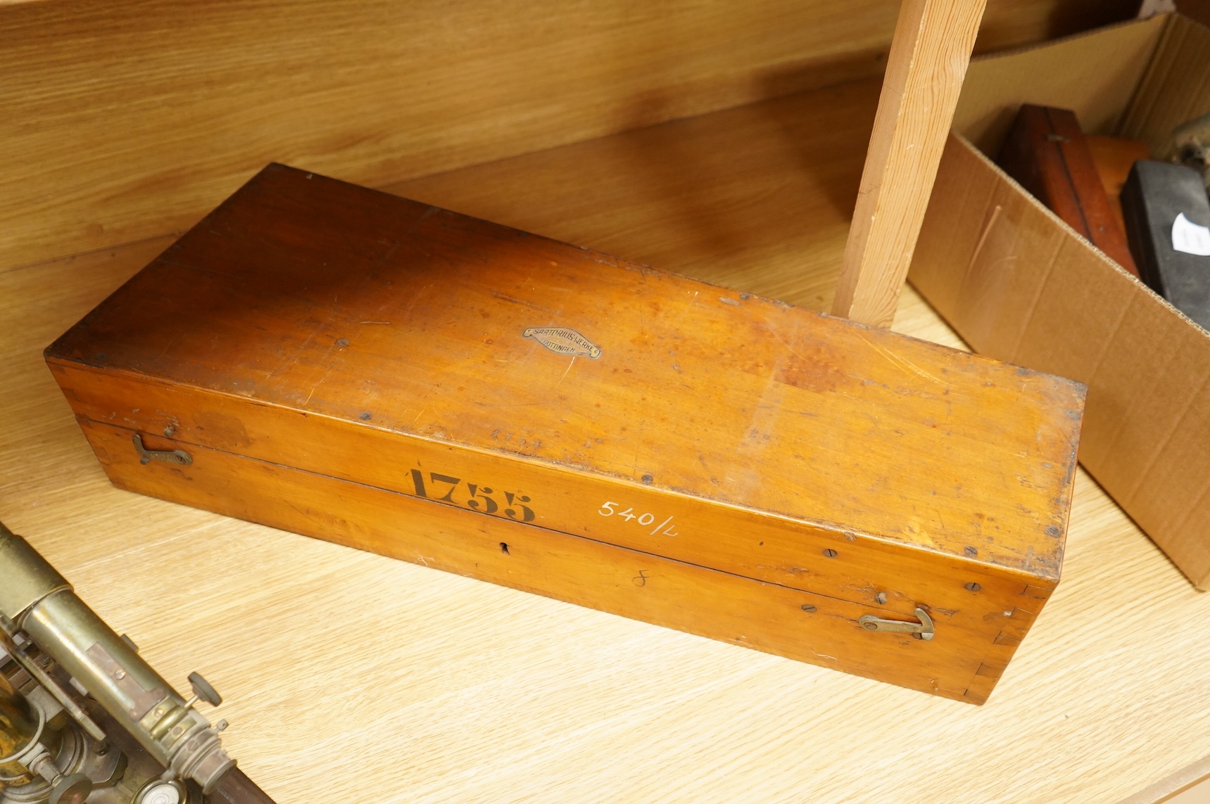 A German brass alidade by F. Sartorius, Göttingen, number 1755, 58.5cm wide, contained within a fitted birch case with applied maker’s label and other reference markings, the case; 63cm wide, 14cm high, 25cm deep at the